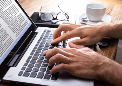 Close-up Of A Person Typing On Laptop